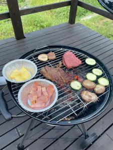 a barbecue grill with meat and vegetables on it at Lulu in Minami Alps