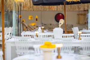 a dining room with white tables and white chairs at ZOE ALAÇATI in Alacati