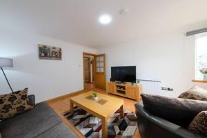 a living room with a couch and a coffee table at Super Prime East Coast Explorer - Inverkeithing in Inverkeithing
