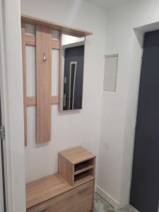 a bathroom with a mirror and a wooden dresser at Apartament NIKOLA in Wadowice