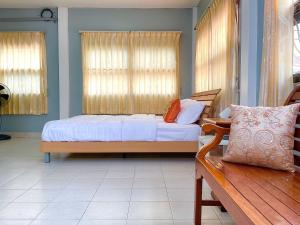 a bedroom with a bed and a bench in it at Private room in Central Pattaya Naeem House in Nong Prue
