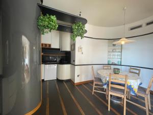 a kitchen and dining room with a table and chairs at Accomodo MIT37 Trivano Niguarda in Milan