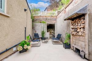 an outdoor patio with chairs and a building at 1 Promenade View in Cromford