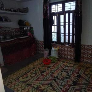a room with a rug on the floor with a window at POP Fareeda Homestay 