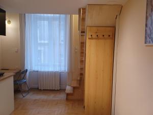 a hallway with a door and a window and a staircase at Loft House Budapest in Budapest