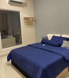 a bedroom with a blue bed and a mirror at Arte Mont Kiara X Sonno in Kuala Lumpur