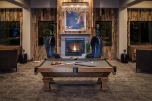 a pool table in a room with a fireplace at SpringHill Suites by Marriott Springdale Zion National Park in Springdale
