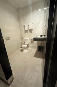 a bathroom with a toilet and a sink at aresidencia sei putih in Medan