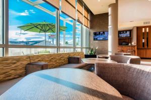 a restaurant with tables and chairs and a large window at SpringHill Suites by Marriott Gallup in Gallup