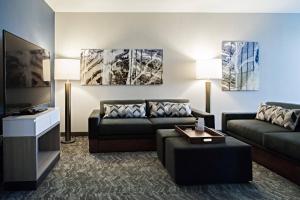 a living room with a couch and a tv at SpringHill Suites by Marriott Somerset Franklin Township in Somerset