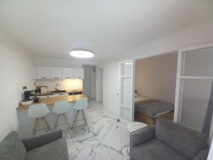 a kitchen and a living room with a table and chairs at Miggle-Moo-Sea in Argelès-sur-Mer