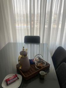 a table with a tea pot and a tray of food at الزمالك ابو الفداء على النيل in Cairo