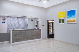 a waiting room at a store with a cash register at Days Inn & Suites by Wyndham Niagara Falls/Buffalo in Niagara Falls