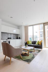 a living room with a couch and a coffee table at Dockside Apartment With Scenic Views in London