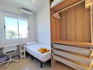 a bedroom with a bed and a desk and a window at Luminoso Apartamento enfrente del AVE in Puertollano