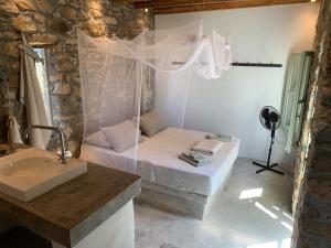a small bedroom with a bed and a sink at Mandri B&B in Serifos Chora +53 photos