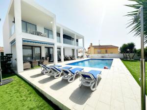 eine Villa mit einem Pool und Liegestühlen in der Unterkunft Luxury villa with large swimming pool and outdoor area in San Fulgencio