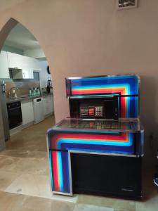 a stove with colorful lights on it in a kitchen at LocN'roll in Semur-en-Auxois +28 photos