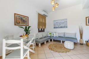 a living room with a couch and a table at Lemon Casa in Skopelos Town +31 photos