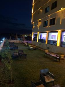 a building with a bunch of benches in front of it at night at Z&A kılıç apart otel in Dargeçit