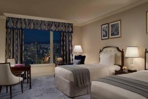a hotel room with two beds and a window at The Ritz-Carlton Osaka in Osaka