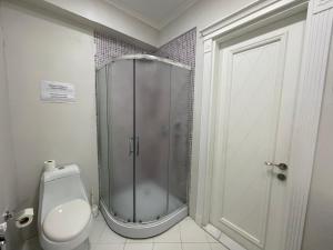 a bathroom with a shower and a toilet in it at Studio Apartment by Bakuapart in Baku