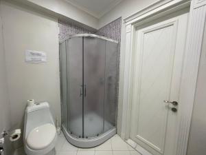 a bathroom with a shower and a toilet in it at Studio Apartment in Baku