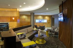 a lobby with a couch and chairs and a television at SpringHill Suites by Marriott Billings in Billings