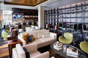 a lobby with a couch and chairs and a bar at SpringHill Suites by Marriott Los Angeles Burbank/Downtown in Burbank