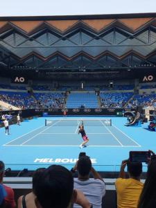 a tennis player on a tennis court with people at Ocean view apartment close to CBD with indoor pool. in Melbourne