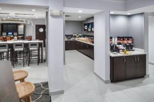 a kitchen and dining room with tables and chairs at SpringHill Suites Milford in Milford