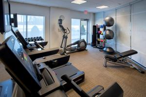 a gym with several cardio machines and a tv in a room at SpringHill Suites by Marriott Albany Latham-Colonie in Albany