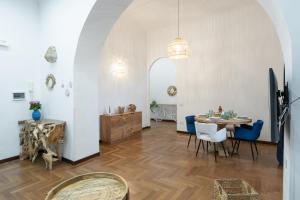 ein Esszimmer mit einem Tisch und blauen Stühlen in der Unterkunft MareLuna Apartment in Neapel