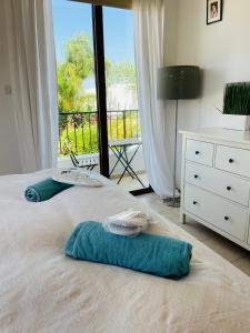 - une chambre avec un lit, des serviettes et une fenêtre dans l'établissement Amazing Villa with a private pool, à Protaras