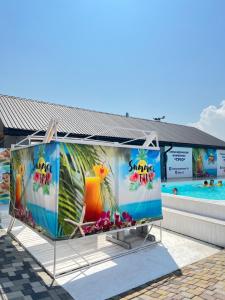 a kiosk at a swimming pool with a large pool at Trio Hotel Restaurant in Ivano-Frankivsk