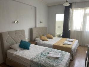 a hotel room with two beds and a window at Tugay Hotel in Fethiye +106 photos