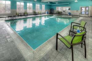 a swimming pool with a chair at SpringHill Suites Anchorage University Lake in Anchorage