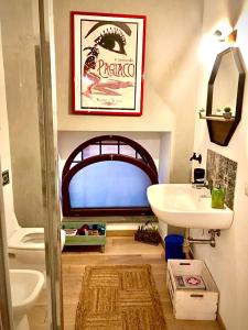 ein Badezimmer mit einem Waschbecken, einem WC und einem Spiegel in der Unterkunft The Place in Orvieto