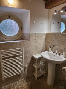 a bathroom with a sink and a window at LA VILLA APARTMENTS - Convenient for Sardinia and Corsica - 5 beds -Private Parking included with Camera in Livorno