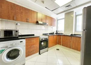 a kitchen with a washer and a dishwasher at RH-Prime Location , Spacious 1 Bedroom near Mall of the Emirates in Dubai