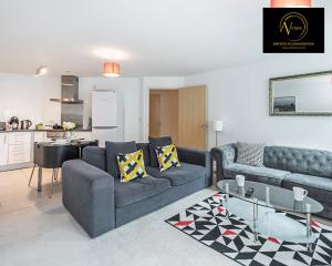 a living room with a couch and a table at 2 Bedroom Apartment by AV Stays Short Lets & Serviced Accommodation in London