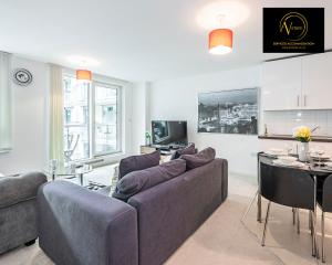ein Wohnzimmer mit einem Sofa und einem Tisch in der Unterkunft 2 Bedroom Apartment by AV Stays Short Lets & Serviced Accommodation in London