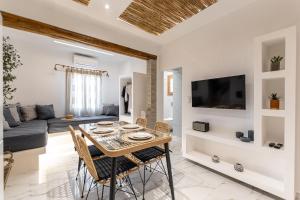 a dining room and living room with a table and chairs at Naxian Serenity Suites in Agia Anna Naxos