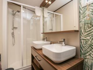 a bathroom with two sinks and a shower at 43 Pony Meadow in Windermere +28 photos