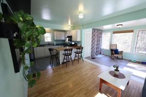 a kitchen and living room with a table and chairs at Little House by the Brook in Fort Fairfield