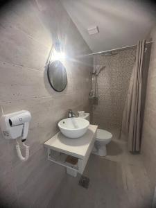 a bathroom with a sink and a toilet at Ama Boutique in Constanţa