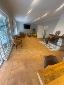 a living room with wooden floors and a fireplace at Exklusiv Villa bei Hamburg 