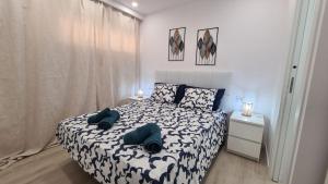 a bedroom with a bed with blue pillows on it at Mariposa Azul in Adeje +39 photos