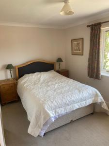 a bedroom with a large bed and a window at Goodwood Rooms in Charlton