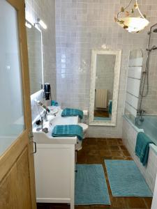 a bathroom with a sink and a mirror at Le Mas Saint Jacques in Le Pontet +23 photos